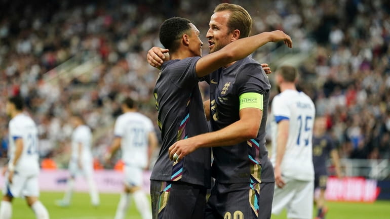 England's Trent Alexander-Arnold celebrates scoring with Harry Kane, right, during...