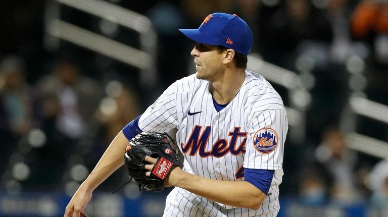 Jacob deGrom of the Mets delivers the final pitch of his...