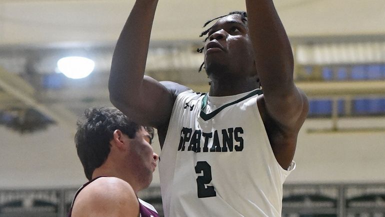 Osagie Ekhator of Elmont, right, sinks a shot and draws...