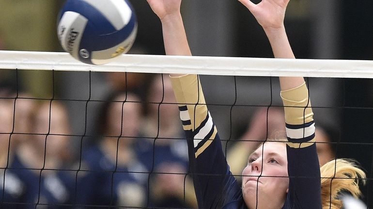 Isabella Imbo #11 of Bayport-Blue Point defends against a spike...