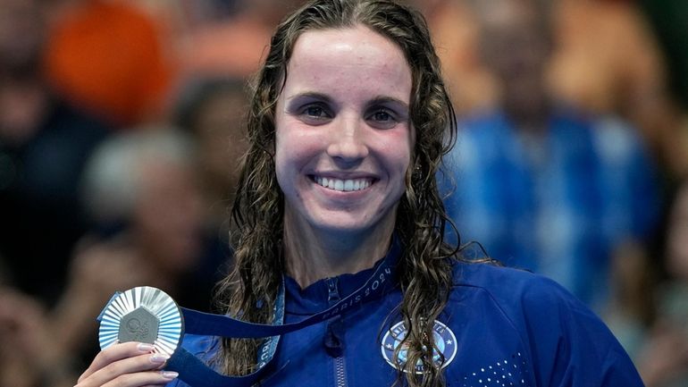 Regan Smith, of the United States, poses with her silver...