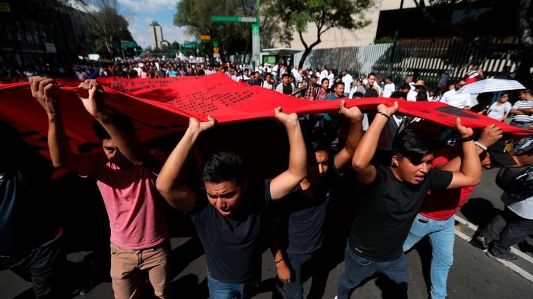 Demonstrators march in remembrance of the 1968 Tlatelolco student massacre,...