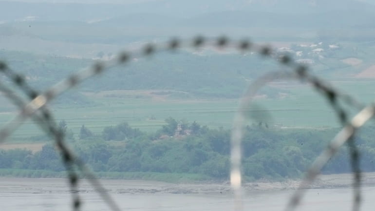 North Korea's military guard post is seen through the wire...