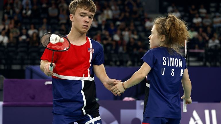 Miles Krajewski, left, and Jayci Simon, from the U.S., high-five...