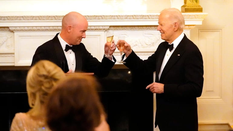 Utah Gov. Spencer Cox, left, and President Joe Biden toast...