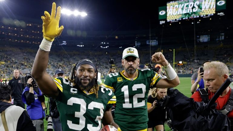 Green Bay Packers running back Aaron Jones (33) and quarterback...