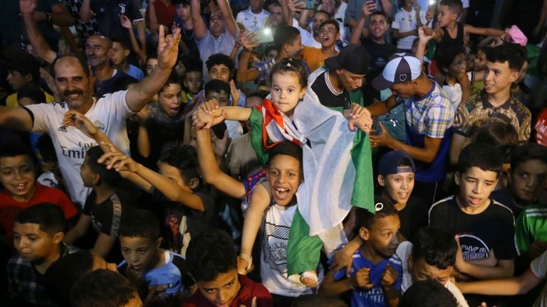 Supporters and relatives watch Algerian boxer Imane Khelif competing in...