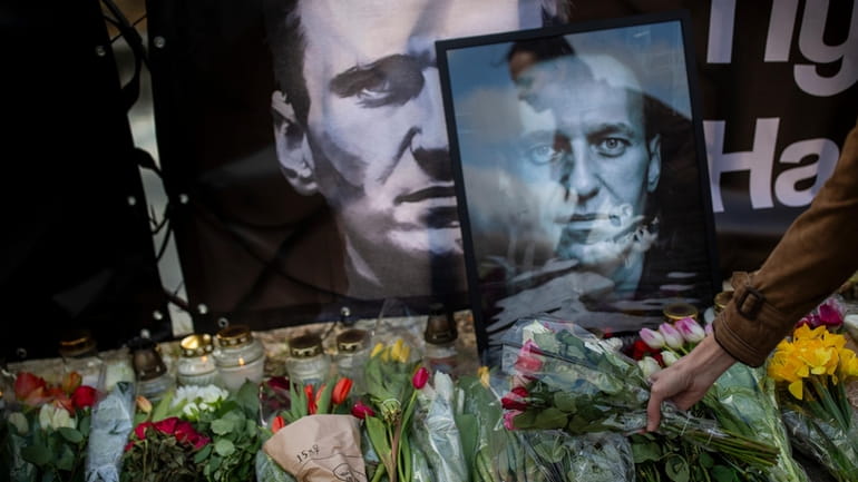 Flowers are laid to pay last respects to Alexei Navalny in front...