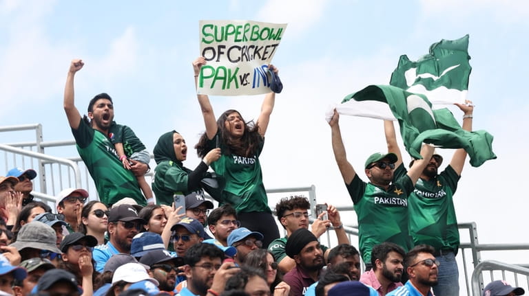 Fans of Pakistan celebrate a score against India during the...