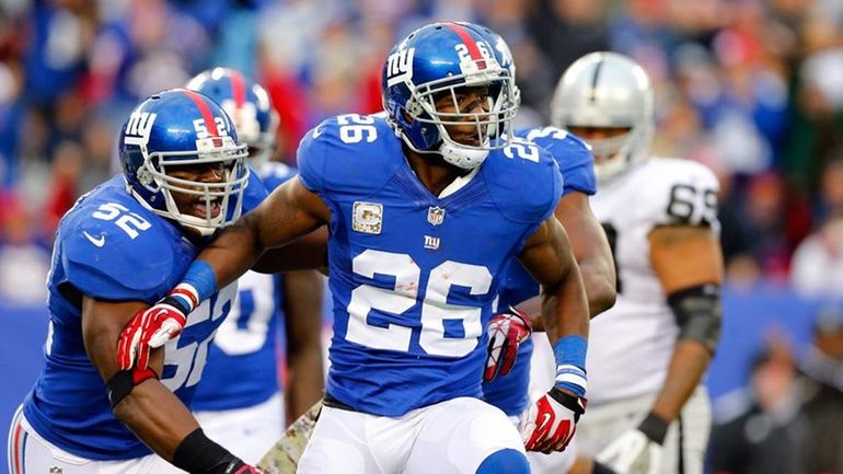 Antrel Rolle celebrates a sack in the fourth quarter of...