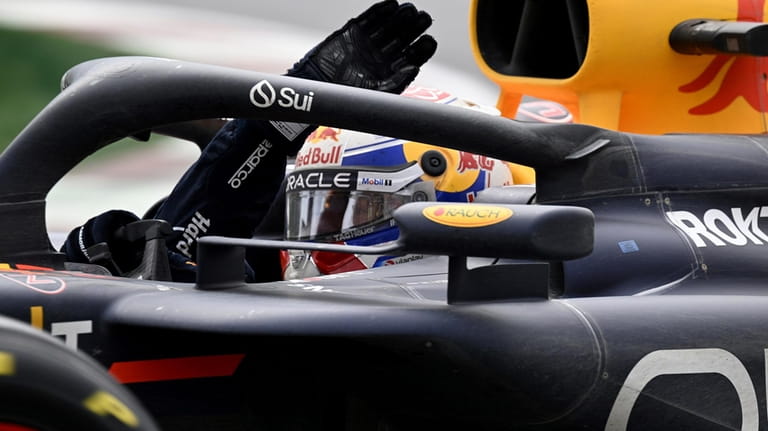Red Bull driver Max Verstappen, of the Netherlands, salutes following...