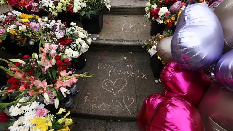 Tributes are seen outside the Town Hall during a vigil...