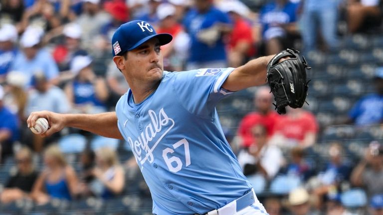 Kansas City Royals starting pitcher Seth Lugo throws to a...