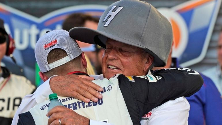 Team owner Rick Hendrick, right, hugs driver William Byron after...