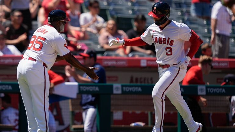 Los Angeles Angels' Taylor Ward (3) celebrates his grand slam...