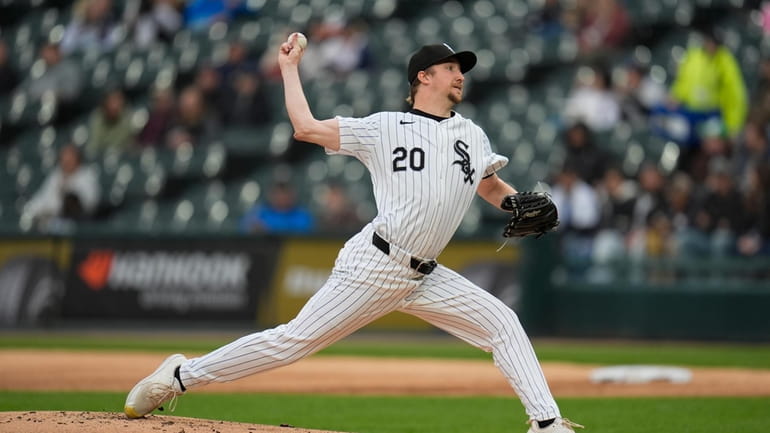 Chicago White Sox starting pitcher Erick Fedde throws to a...