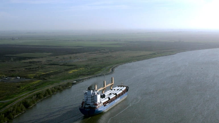A ship moves through the Sacramento-San Joaquin River Delta near...