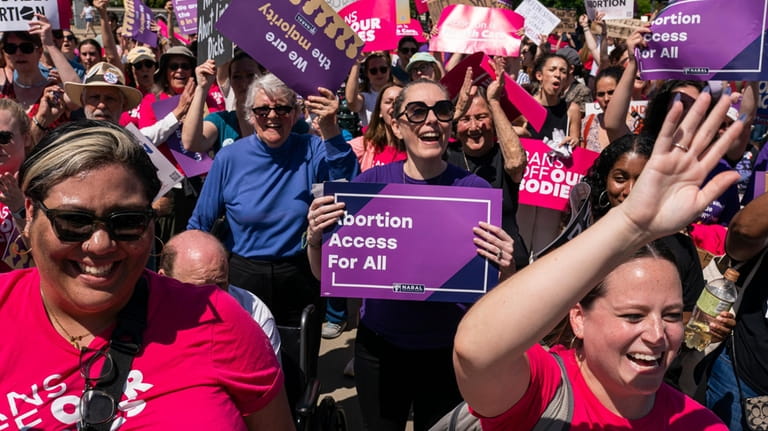 Protesters cheer during a Planned Parenthood rally in support of...