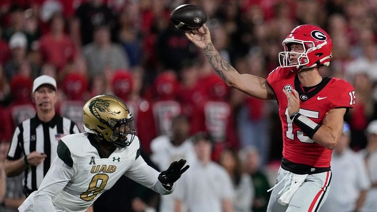 Georgia quarterback Carson Beck (15) throws under pressure from UAB...