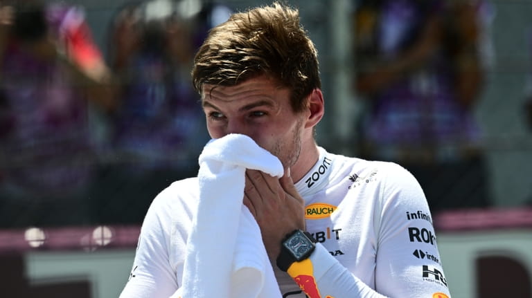 Red Bull driver Max Verstappen of the Netherlands reacts after...