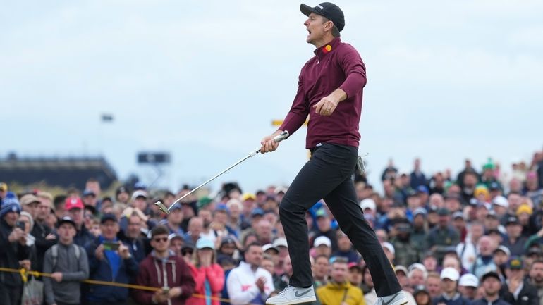 Justin Rose of England reacts after missing a putt on...