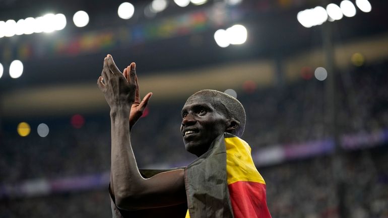 Gold medalist Joshua Cheptegei, of Uganda, celebrates after the men's...