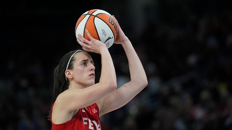 Indiana Fever guard Caitlin Clark looks to take a free...