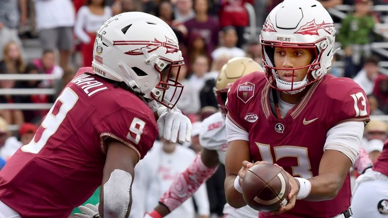 Florida State quarterback Jordan Travis (13) hands the ball off...