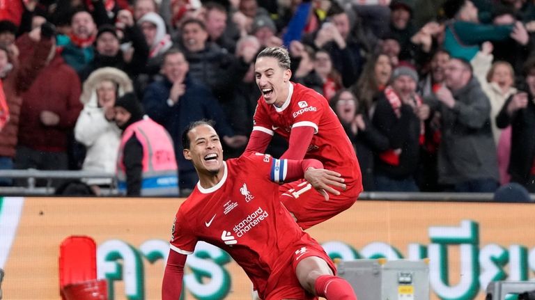 Liverpool's Virgil van Dijk celebrates after scoring his side's first...