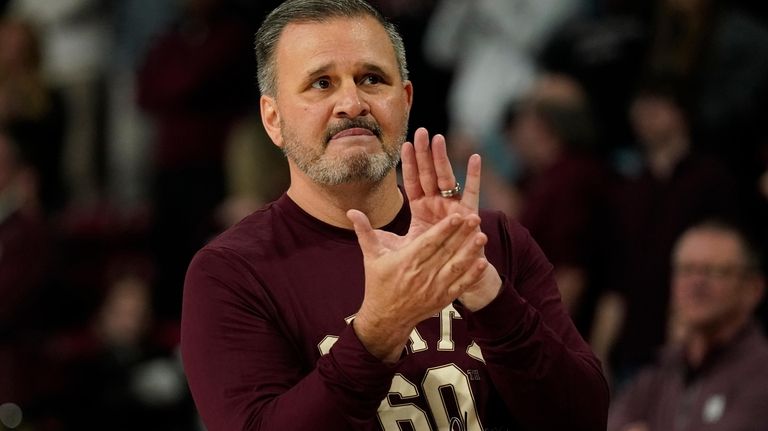 Mississippi State head coach Chris Jans salutes students and fans...