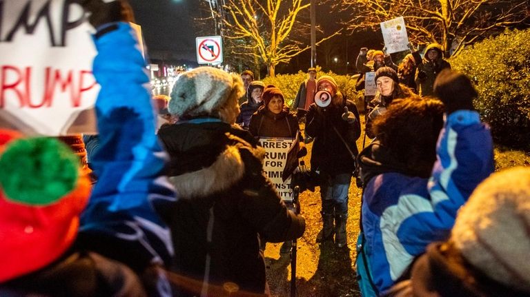 Demonstrators gather Tuesday at the corner of Route 110 and Jericho...