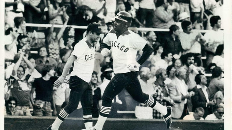 White Sox first baseman Lamar Johnson heads for home plate...