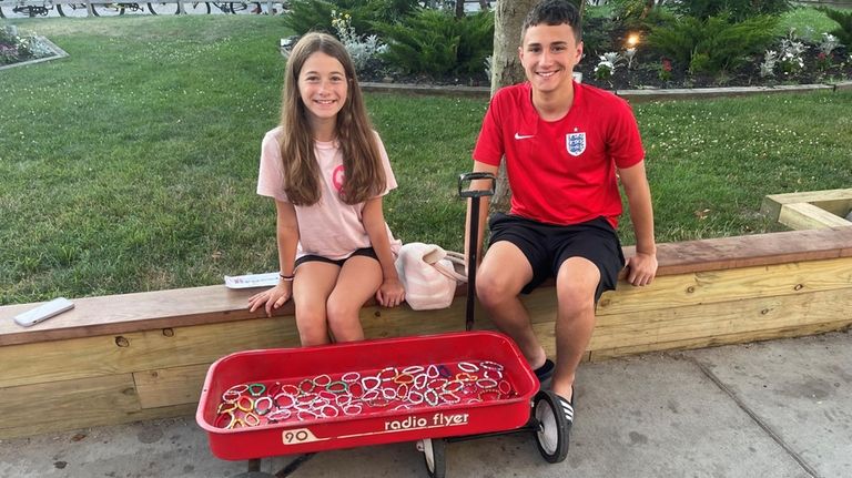 Caelyn Liardi, 12, of Massapequa Park, sells homemade bracelets in...