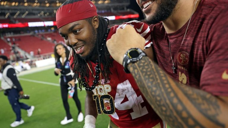 San Francisco 49ers' Jordan Mason and Talanoa Hufanga celebrate after...