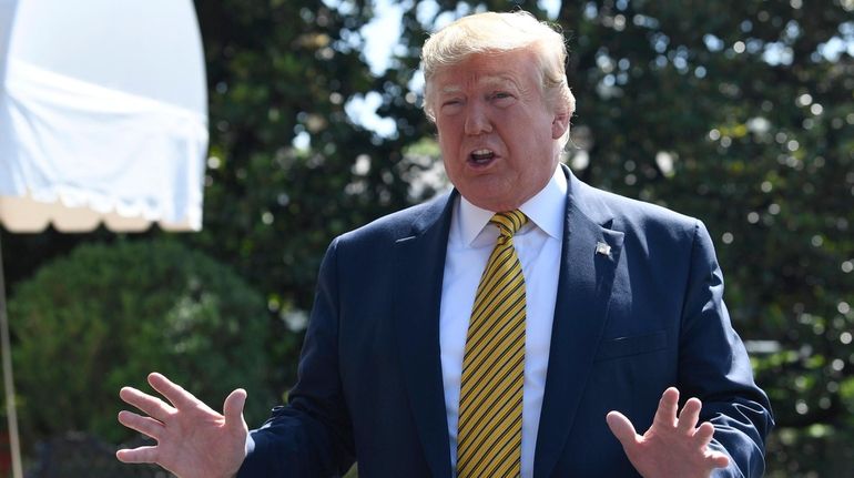 President Donald Trump speaks to reporters on the South Lawn...