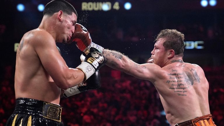 Canelo Alvarez hits Edgar Berlanga in a super middleweight title...