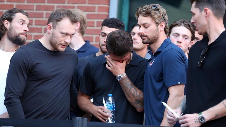 Columbus Blue Jackets player Cole Sillinger, center, reacts during the...