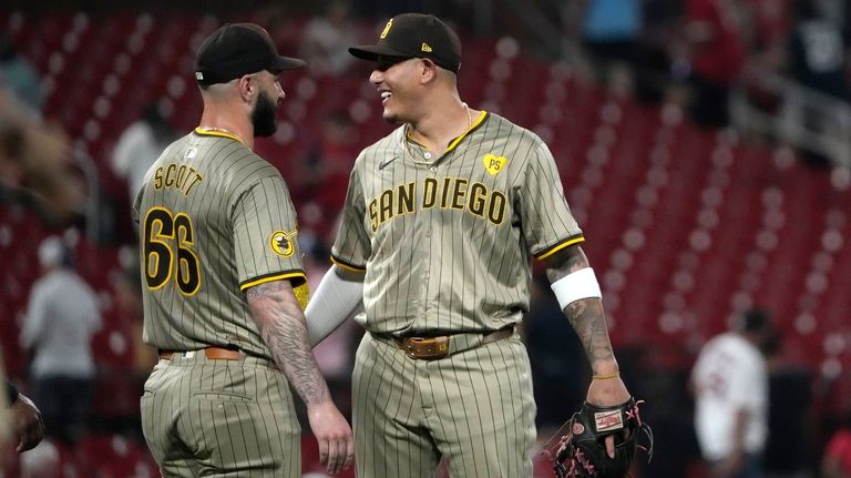 San Diego Padres Tanner Scott and teammate Manny Machado celebrate...