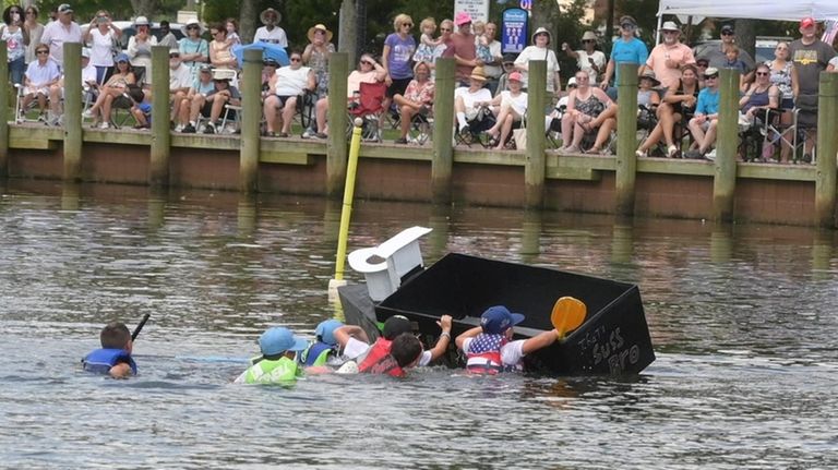 Some of the racers get wet at the Riverhead Cardboard...