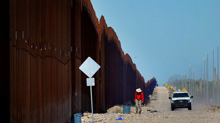 Retired schoolteacher Tom Wingo, of Samaritans Without Borders, walks on...