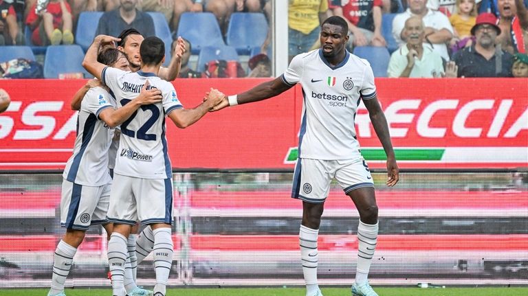 Inter's Marcus Thuram, right, celebrates after scoring during the Serie...