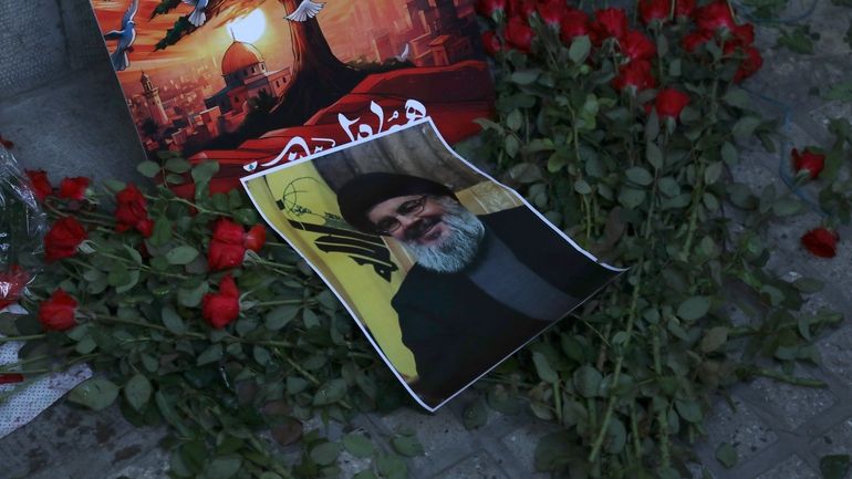 A poster of Hezbollah leader Sayyed Hassan Nasrallah is placed...