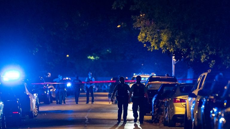 Chicago police work the scene where two police officers where...