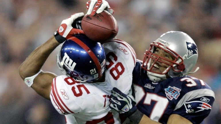 David Tyree makes the grab against Patriots safety Rodney Harrison...