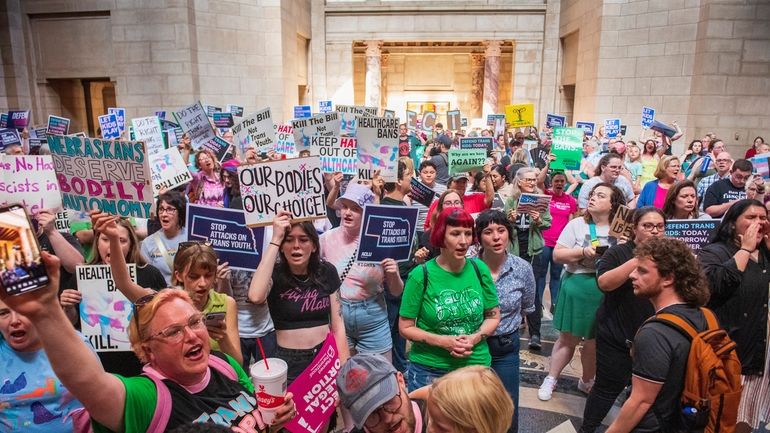 Protesters chant as they are heard in the legislative chamber...