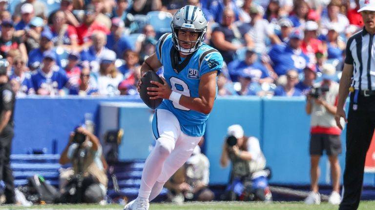 Carolina Panthers quarterback Bryce Young (9) scrambles in the first...