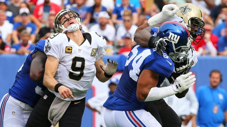 Drew Brees of the New Orleans Saints is hit by...
