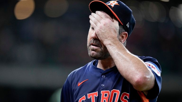 Houston Astros starting pitcher Justin Verlander walks to the dugout...