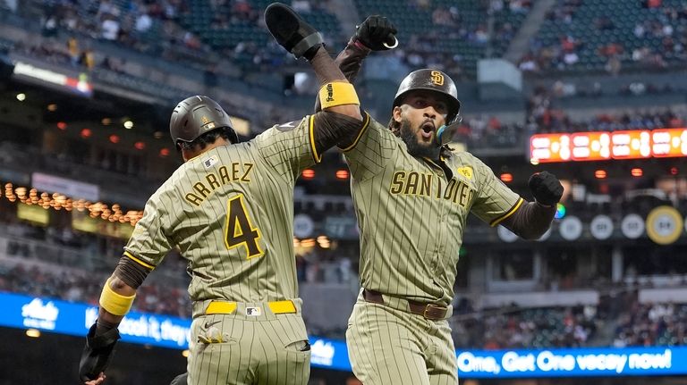 San Diego Padres' Fernando Tatis Jr., right, celebrates after hitting...