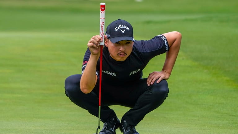 Australia's Min Woo Lee prepares to putt on the second...